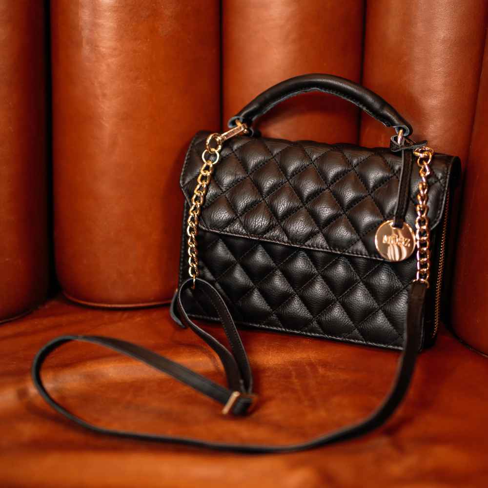 Handtas dames quilted zwart op stoel